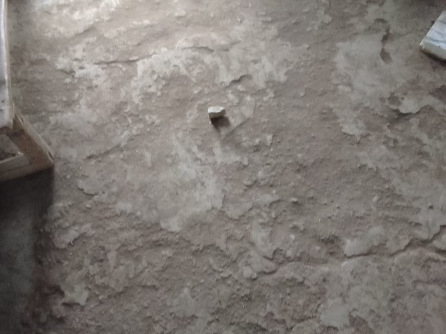 Damaged classroom floor before repair